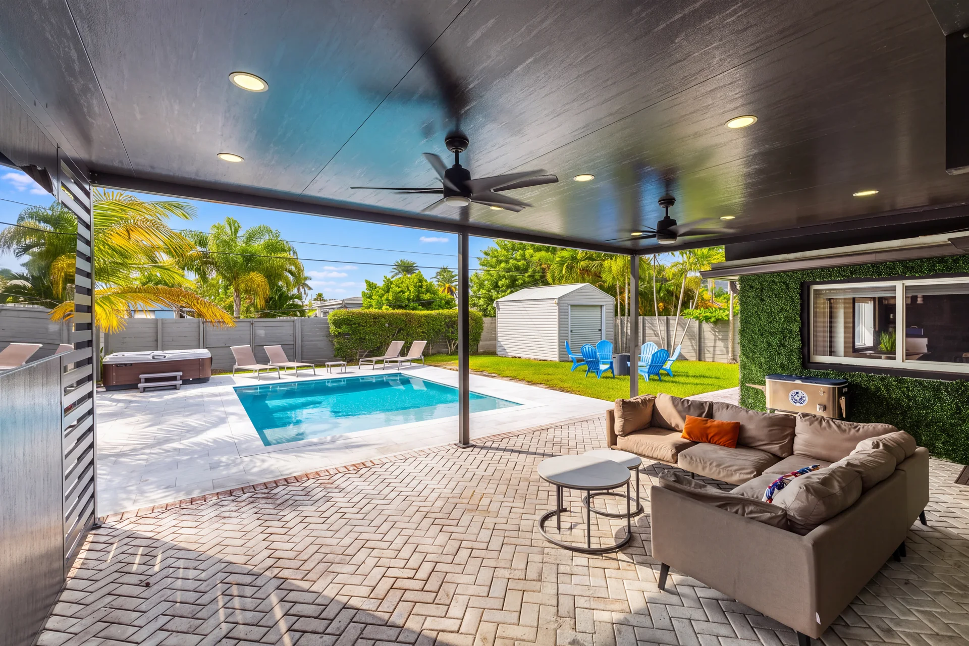 Covered entertainment lounge overlooking the swimming pool