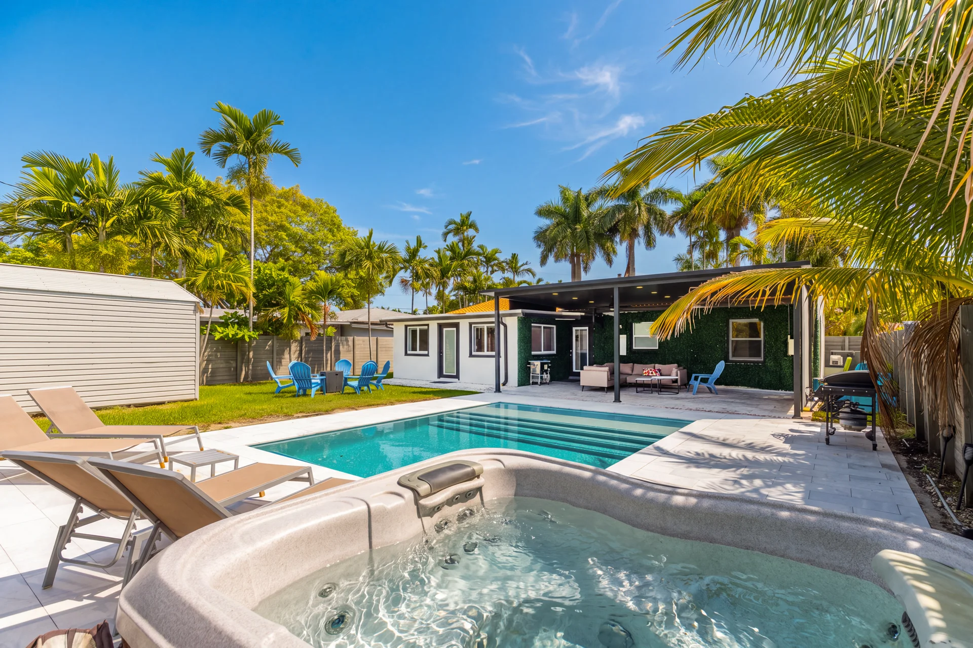 Jacuzzi beside the pool and sun loungers